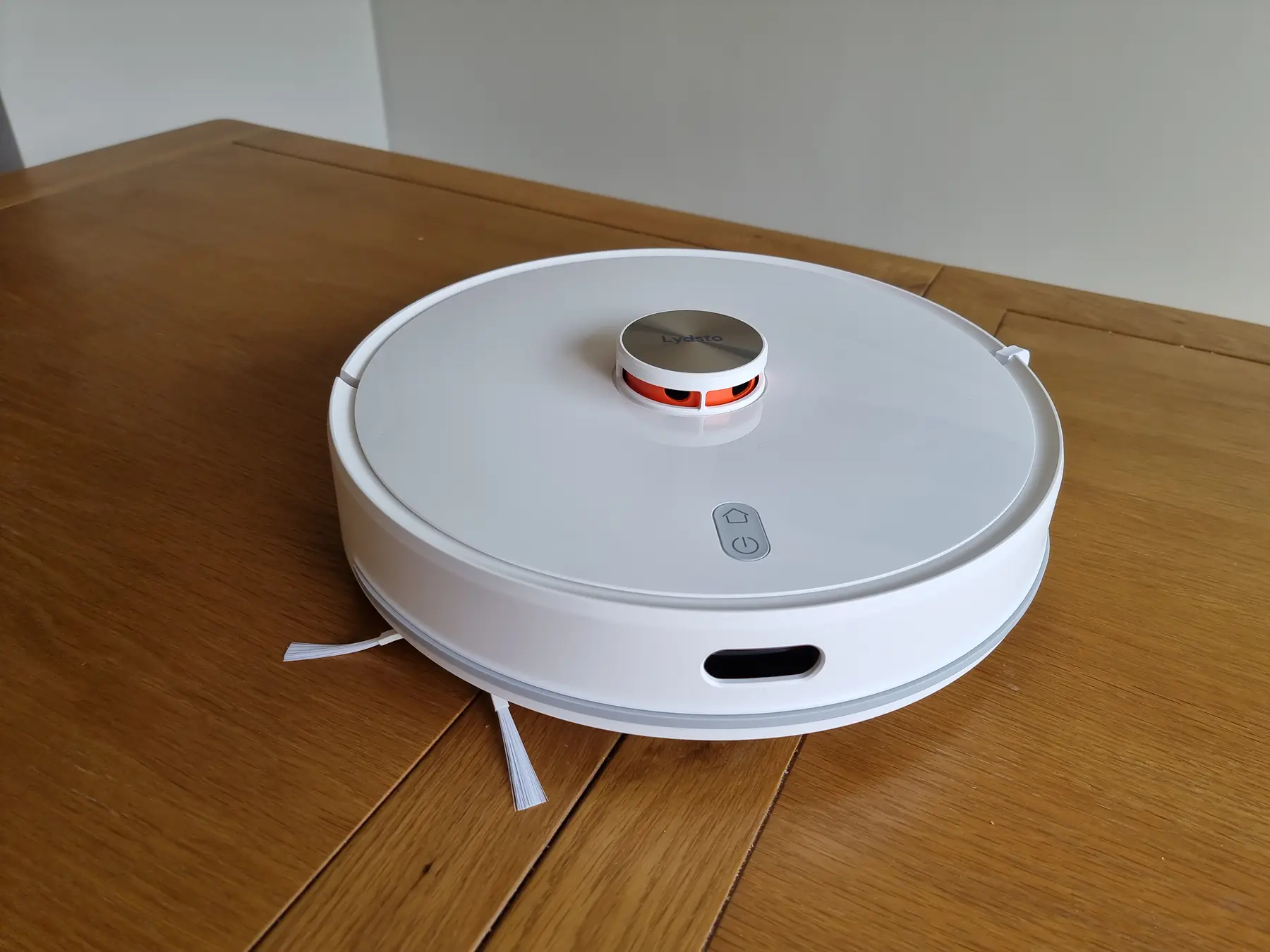 White robot vacuum with a raised LiDAR navigation turret and dark front panel